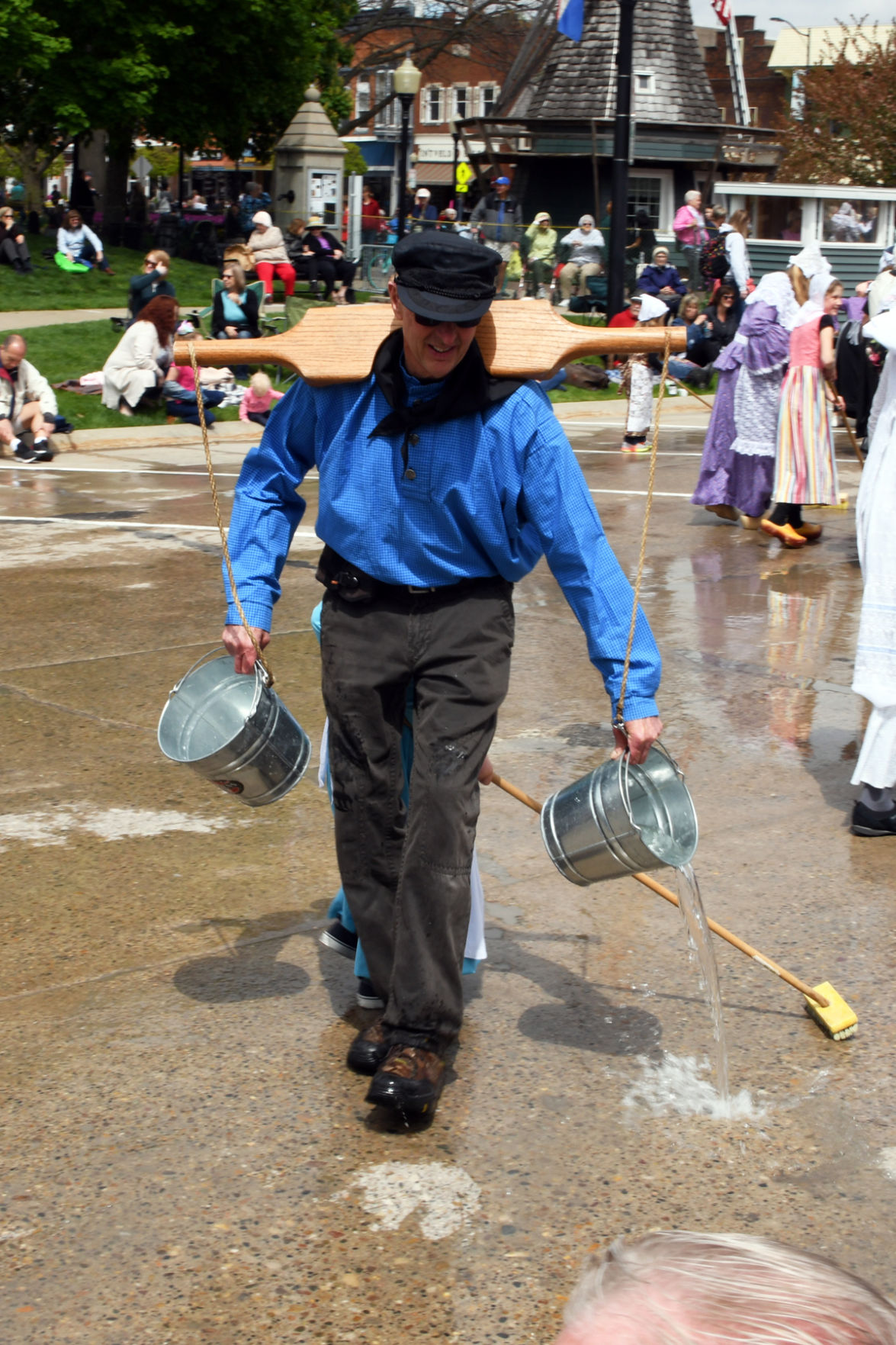 238 Men wear yokes to help them carry the buckets of water for the street scrubbers.JPG